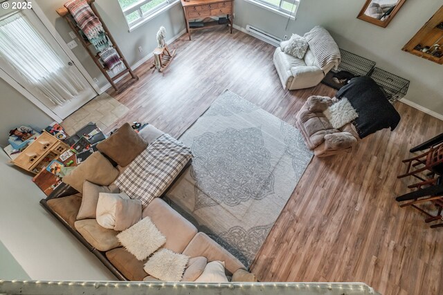 11885 Riverhaven Ln SE, Stayton, OR 97383 - living area with baseboard heating, plenty of natural light, wood finished floors, and baseboards