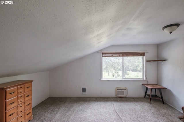 11885 Riverhaven Ln SE, Stayton, OR 97383 - bonus room featuring vaulted ceiling, a textured ceiling, and carpet floors