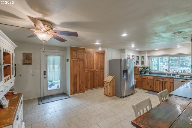 11885 Riverhaven Ln SE, Stayton, OR 97383 - kitchen featuring stainless steel appliances, brown cabinets, ceiling fan, glass insert cabinets, and dark countertops