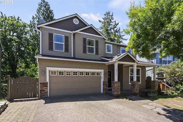 3541 SW Wonderview Ave, Gresham, OR 97080 - craftsman house featuring a porch, stone siding, asphalt driveway, a garage, and a gate