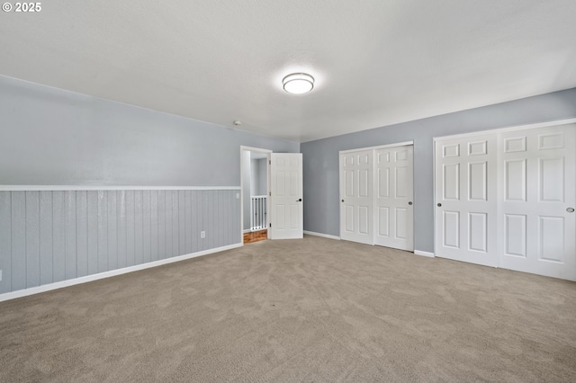 3541 SW Wonderview Ave, Gresham, OR 97080 - unfurnished bedroom with two closets, carpet flooring, and baseboards