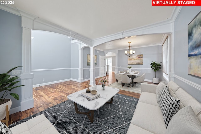 3541 SW Wonderview Ave, Gresham, OR 97080 - living area featuring arched walkways, decorative columns, ornamental molding, wood finished floors, and a chandelier