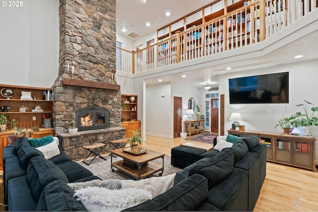 20015 NE 234th St, Battle Ground, WA 98604 - living area featuring a towering ceiling, wood finished floors, a fireplace, and recessed lighting