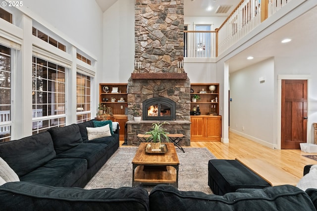 20015 NE 234th St, Battle Ground, WA 98604 - living area featuring a high ceiling, wood finished floors, a stone fireplace, and baseboards