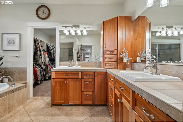 20015 NE 234th St, Battle Ground, WA 98604 - bathroom featuring tile patterned flooring, a stall shower, double vanity, a spacious closet, and a garden tub