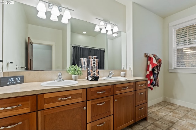 20015 NE 234th St, Battle Ground, WA 98604 - full bathroom with baseboards, double vanity, and stone finish floors
