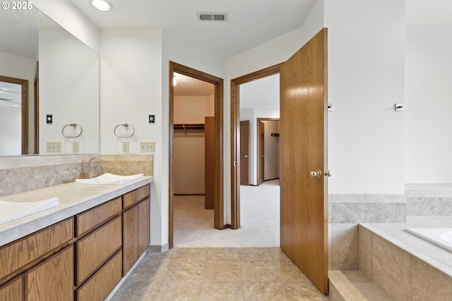1324 Stonehaven Dr, West Linn, OR 97068 - bathroom featuring a walk in closet, double vanity, tiled tub, and tile patterned floors