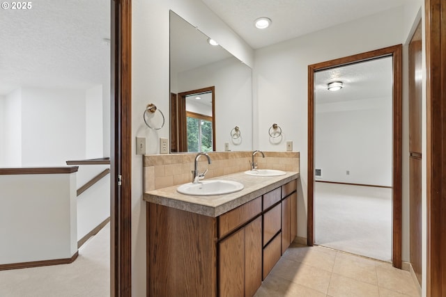 1324 Stonehaven Dr, West Linn, OR 97068 - bathroom featuring tasteful backsplash, double vanity, a textured ceiling, baseboards, and tile patterned flooring