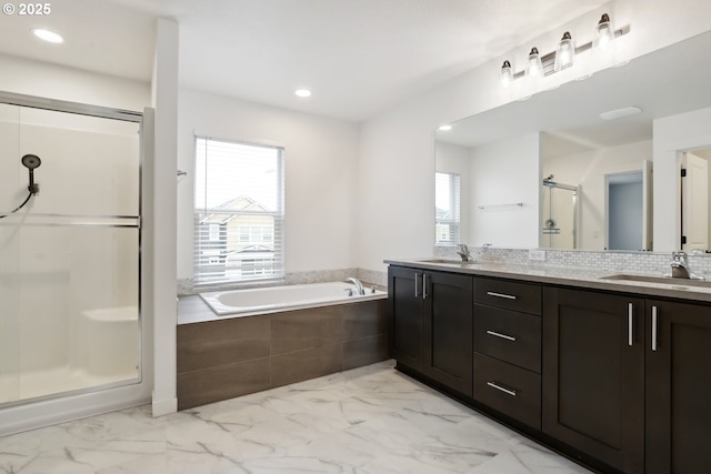 bathroom with vanity and separate shower and tub