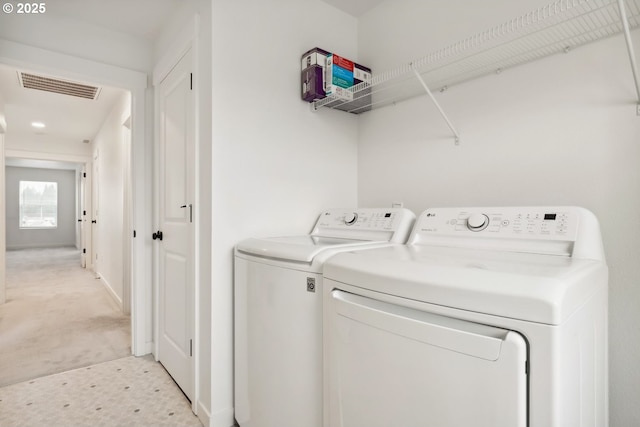 washroom featuring washing machine and clothes dryer