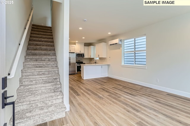 7762 SW Bonita Blvd, Tigard, OR 97224 - kitchen with appliances with stainless steel finishes, light countertops, light wood-type flooring, baseboards, and a sink