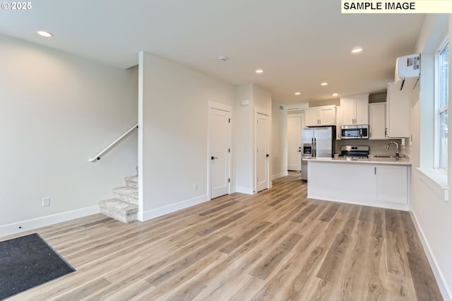 7762 SW Bonita Blvd, Tigard, OR 97224 - kitchen with appliances with stainless steel finishes, light wood-type flooring, open floor plan, baseboards, and recessed lighting