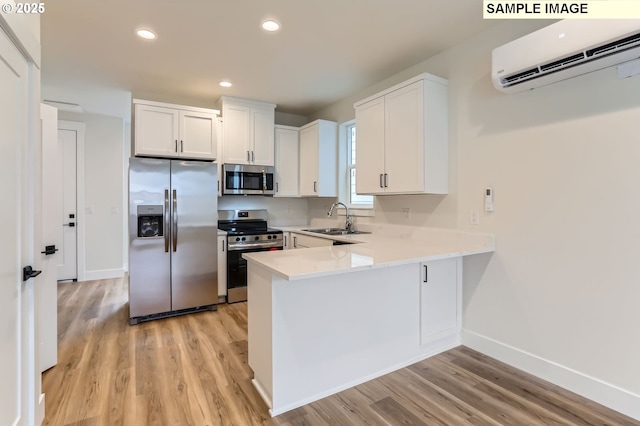 7762 SW Bonita Blvd, Tigard, OR 97224 - kitchen featuring stainless steel appliances, a wall mounted AC, a sink, light wood-style floors, and light countertops