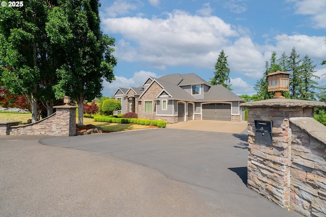 21106 NW 3rd Ct, Ridgefield, WA 98642 - craftsman-style home with asphalt driveway, stone siding, and an attached garage