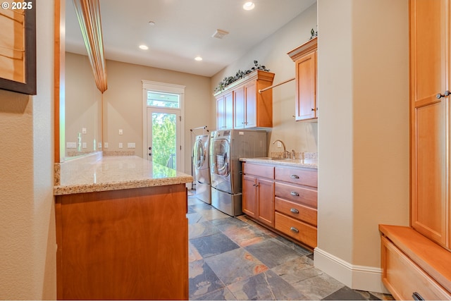 21106 NW 3rd Ct, Ridgefield, WA 98642 - washroom featuring cabinet space, washer and dryer, dark stone finish flooring, and recessed lighting