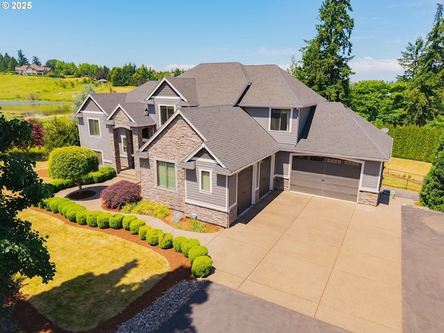 21106 NW 3rd Ct, Ridgefield, WA 98642 - craftsman inspired home with stone siding, an attached garage, concrete driveway, and a water view