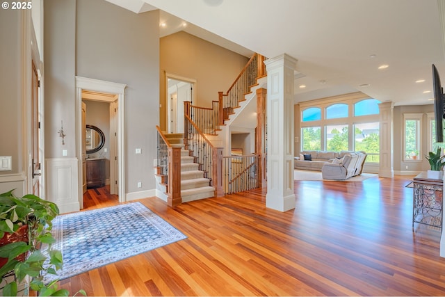 21106 NW 3rd Ct, Ridgefield, WA 98642 - entryway with ornate columns, wood finished floors, stairs, a high ceiling, and recessed lighting