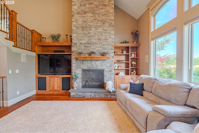 21106 NW 3rd Ct, Ridgefield, WA 98642 - living room featuring wood finished floors, high vaulted ceiling, a stone fireplace, and stairs