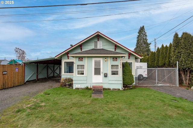 bungalow-style home with a front yard and a carport