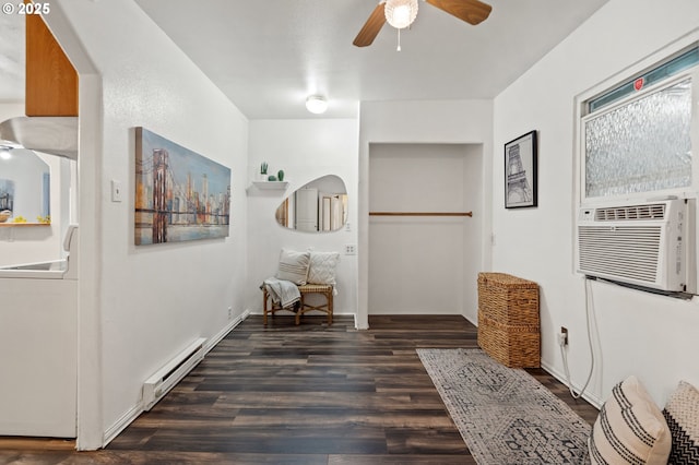 hallway featuring cooling unit, baseboard heating, dark wood-type flooring, and sink