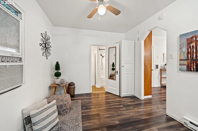 sitting room featuring dark hardwood / wood-style floors, ceiling fan, and baseboard heating