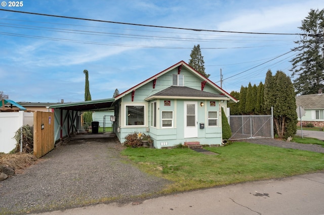 bungalow-style house with a front lawn and a carport