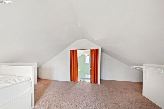 additional living space featuring carpet and lofted ceiling