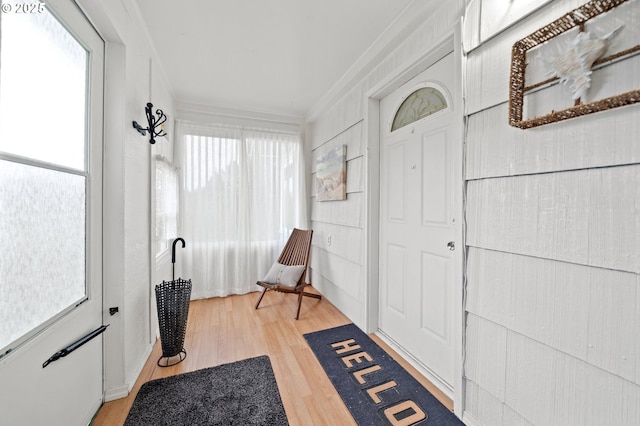 interior space with hardwood / wood-style floors and crown molding