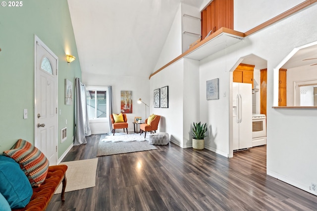 foyer entrance featuring dark hardwood / wood-style floors, high vaulted ceiling, and ceiling fan