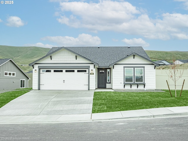 885 Yoss Pl, Cottage Grove, OR 97424 - single story home featuring concrete driveway, a shingled roof, an attached garage, and a mountain view