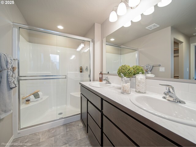885 Yoss Pl, Cottage Grove, OR 97424 - bathroom with a shower stall, double vanity, stone finish flooring, recessed lighting, and a spacious closet