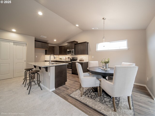 885 Yoss Pl, Cottage Grove, OR 97424 - dining room featuring lofted ceiling, light wood-style floors, baseboards, and recessed lighting