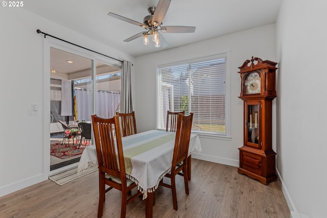 dining room with baseboards, a ceiling fan, and light wood-style floors