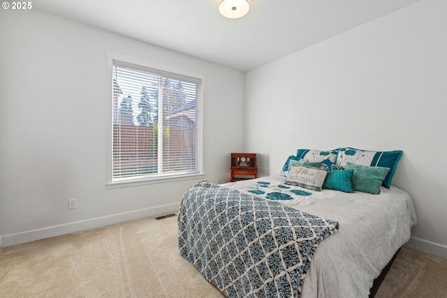 bedroom with carpet, visible vents, and baseboards