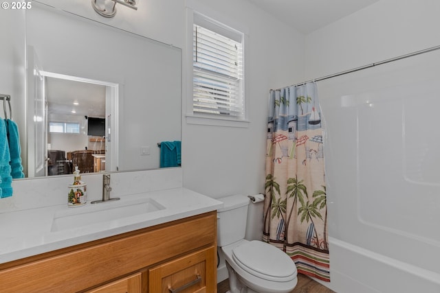 full bath with toilet, shower / tub combo, and vanity