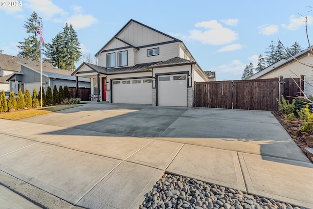 view of front of house featuring concrete driveway, board and batten siding, an attached garage, and fence