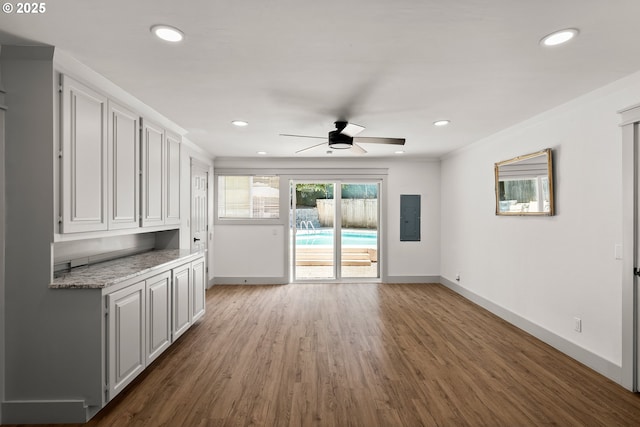 22692 SW Highland Dr, Sherwood, OR 97140 - unfurnished living room with electric panel, baseboards, wood finished floors, and recessed lighting