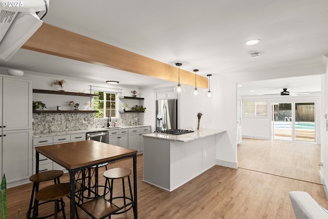22692 SW Highland Dr, Sherwood, OR 97140 - kitchen featuring stainless steel appliances, open shelves, tasteful backsplash, a peninsula, and ceiling fan