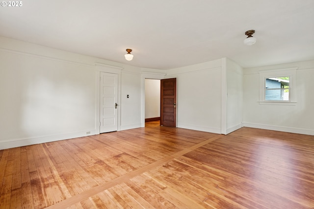 unfurnished room featuring light wood-style flooring and baseboards