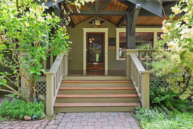 view of exterior entry featuring covered porch