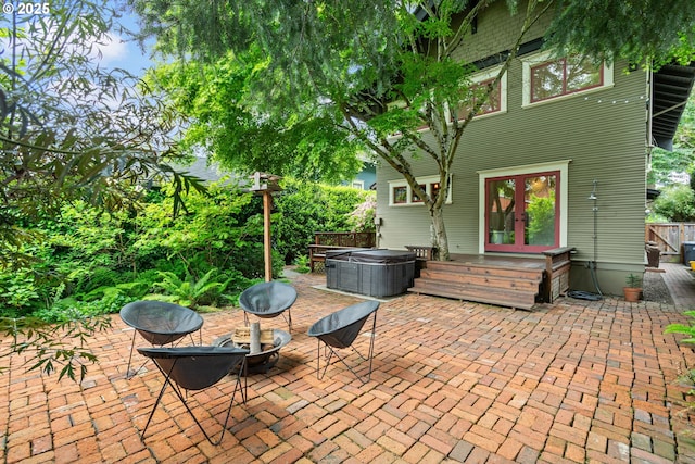 view of patio featuring central air condition unit, french doors, and a hot tub