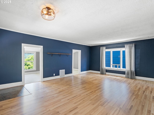 6310 SW 35th Ave, Portland, OR 97221 - unfurnished living room featuring a textured ceiling, wood finished floors, and crown molding