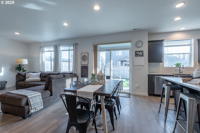 dining space featuring plenty of natural light, light wood-type flooring, and recessed lighting