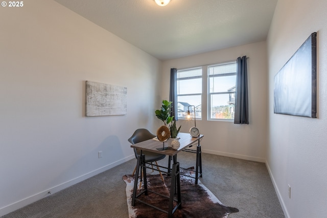 home office featuring dark carpet and baseboards