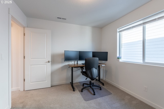 office space featuring carpet, visible vents, and baseboards