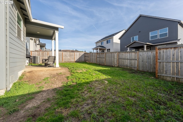 view of yard with a fenced backyard and central air condition unit