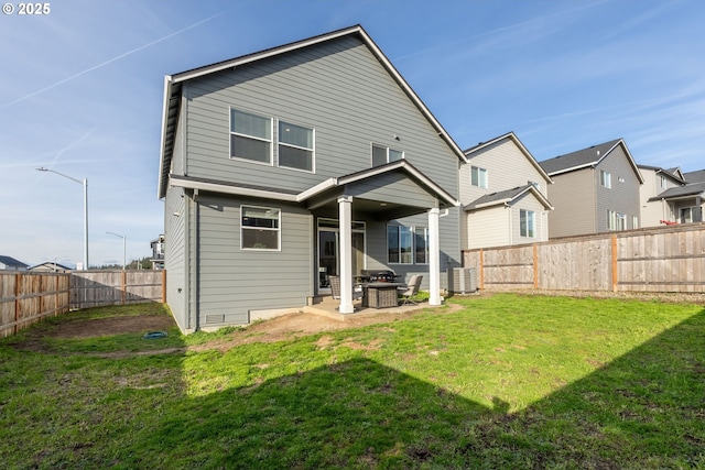 back of house with a yard, a patio, and a fenced backyard