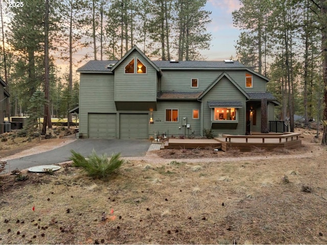 view of front of home with a garage and aphalt driveway