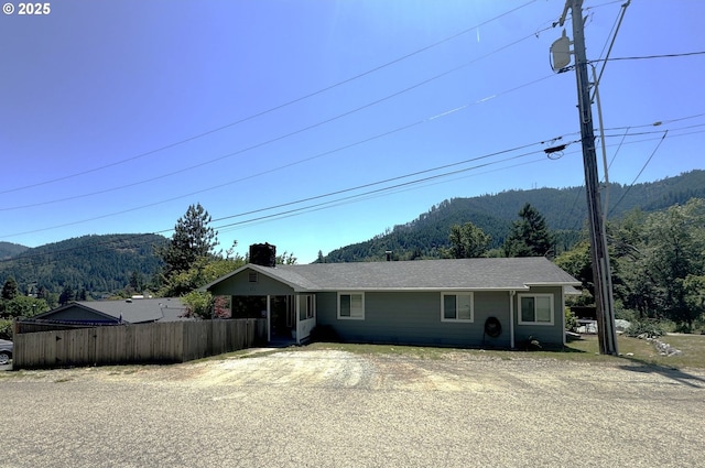 611 Fairchild St, Canyonville, OR 97417 - view of front of house with a mountain view, a chimney, and a shingled roof