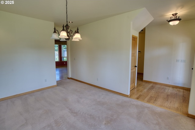1317 Riggleman Ln, White Salmon, WA 98672 - empty room featuring a chandelier, baseboards, carpet floors, and wood finished floors